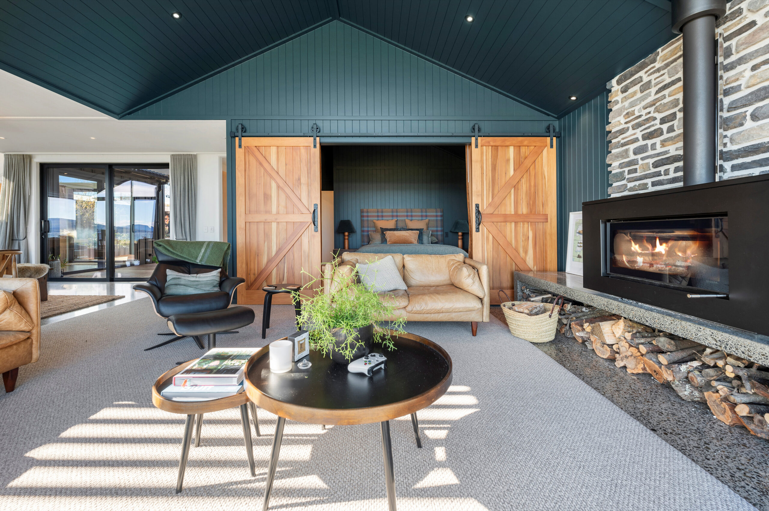 This Large freestanding fire sitting on the custom built polished concrete hearth is the focal point of this living room.