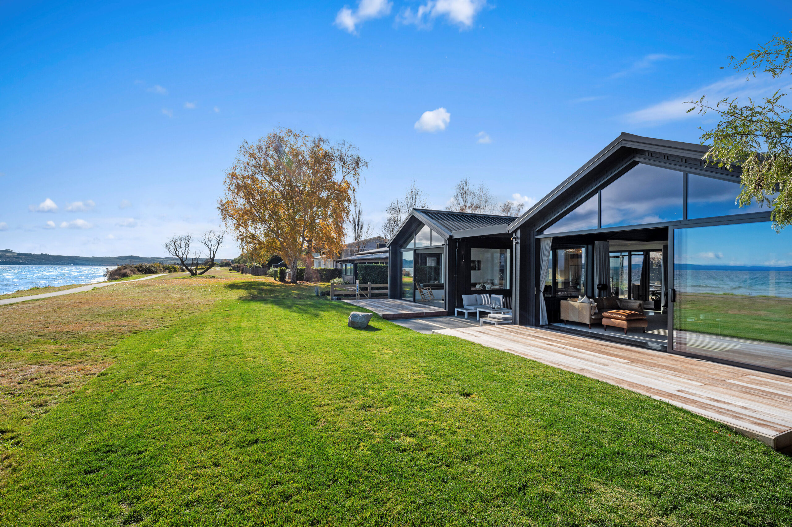 Outdoor living area on the edge of Lake Taupo for this architectural home constructed by Built Spaces.