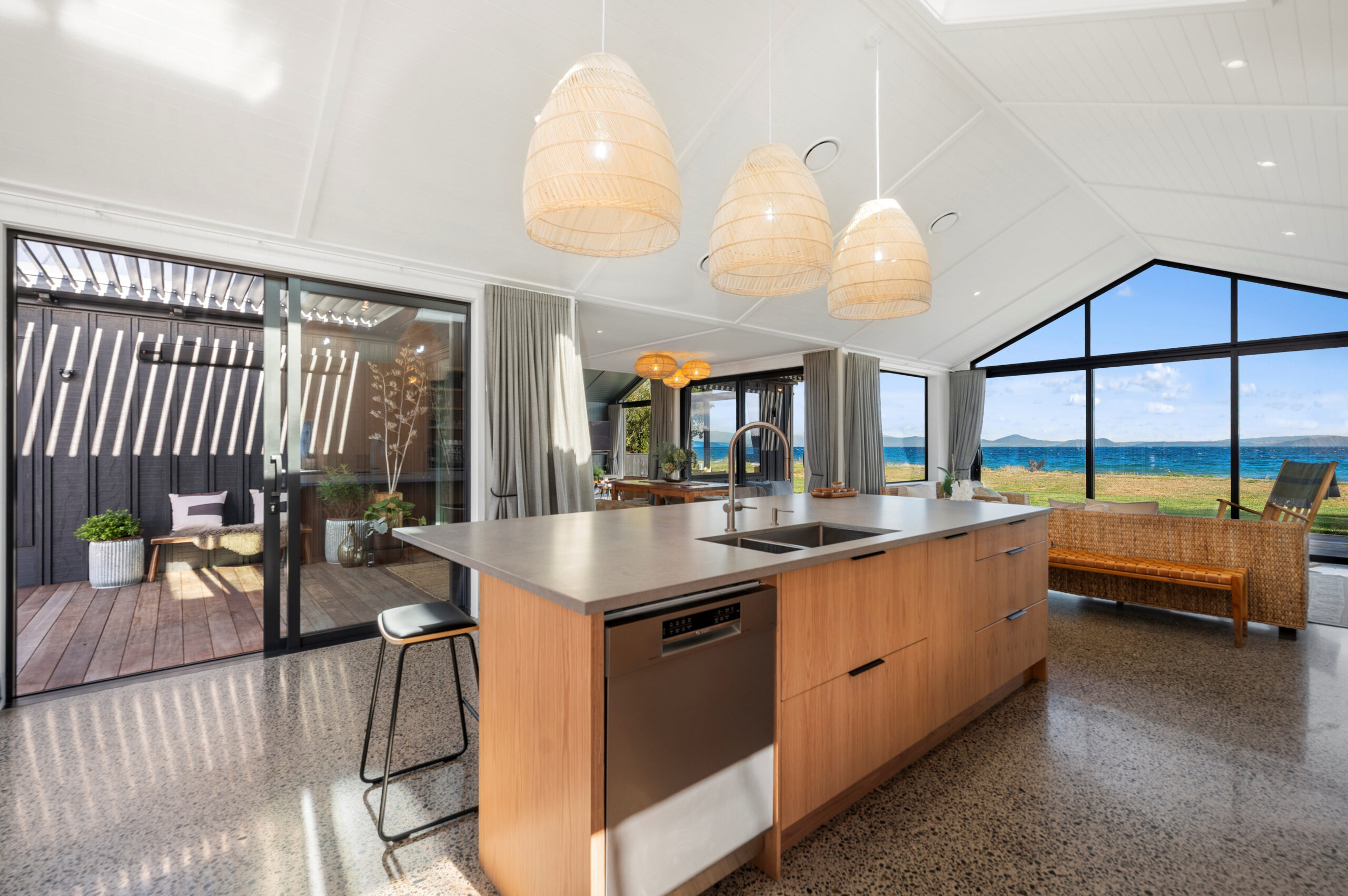 The view of Taupo from the kitchen through the use of Large raking windows is credit to the architect, who has created this luxury piece of Real Estate.