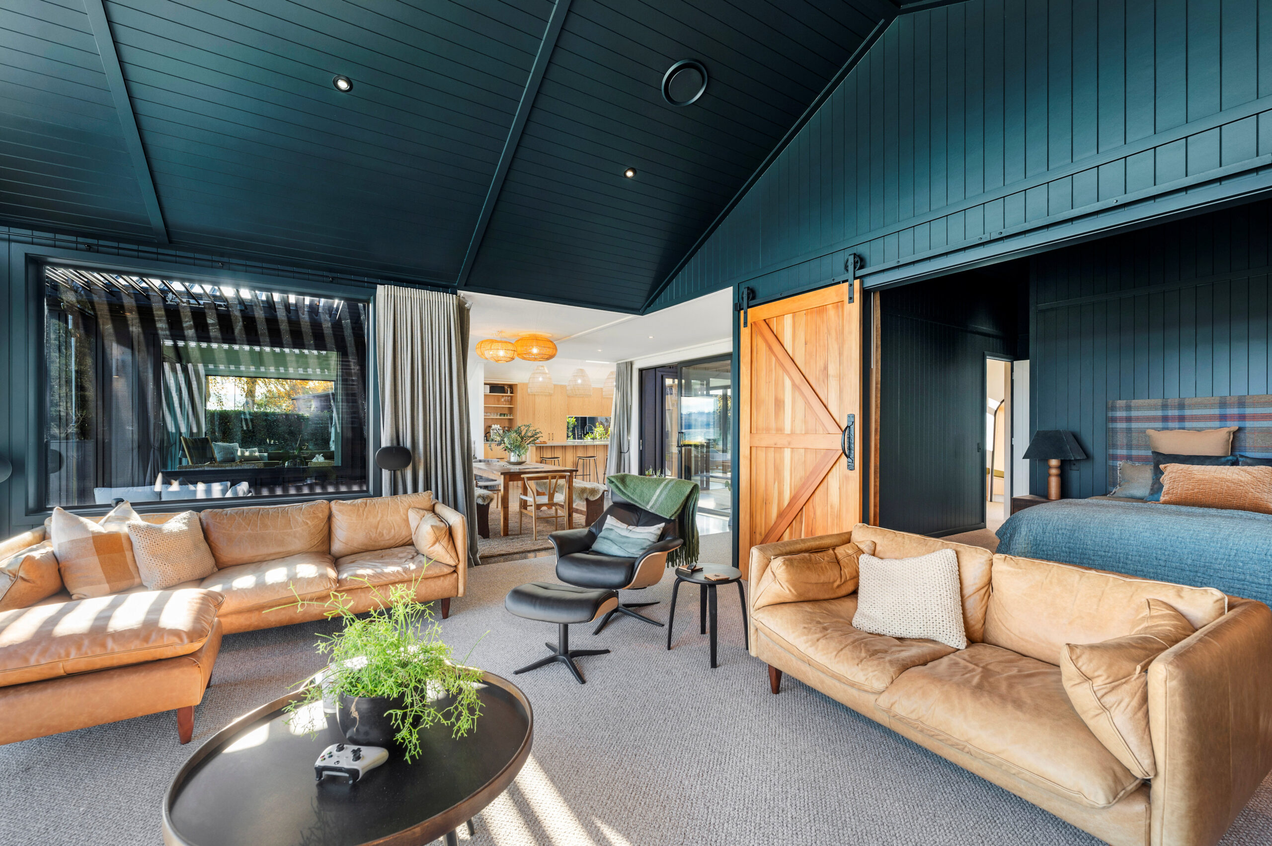 Natural tones blend throughout from the barn doors to the soft furnishings as a reflection of the colours from Lake Taupo, This thoughtful interior design completes Custom home.