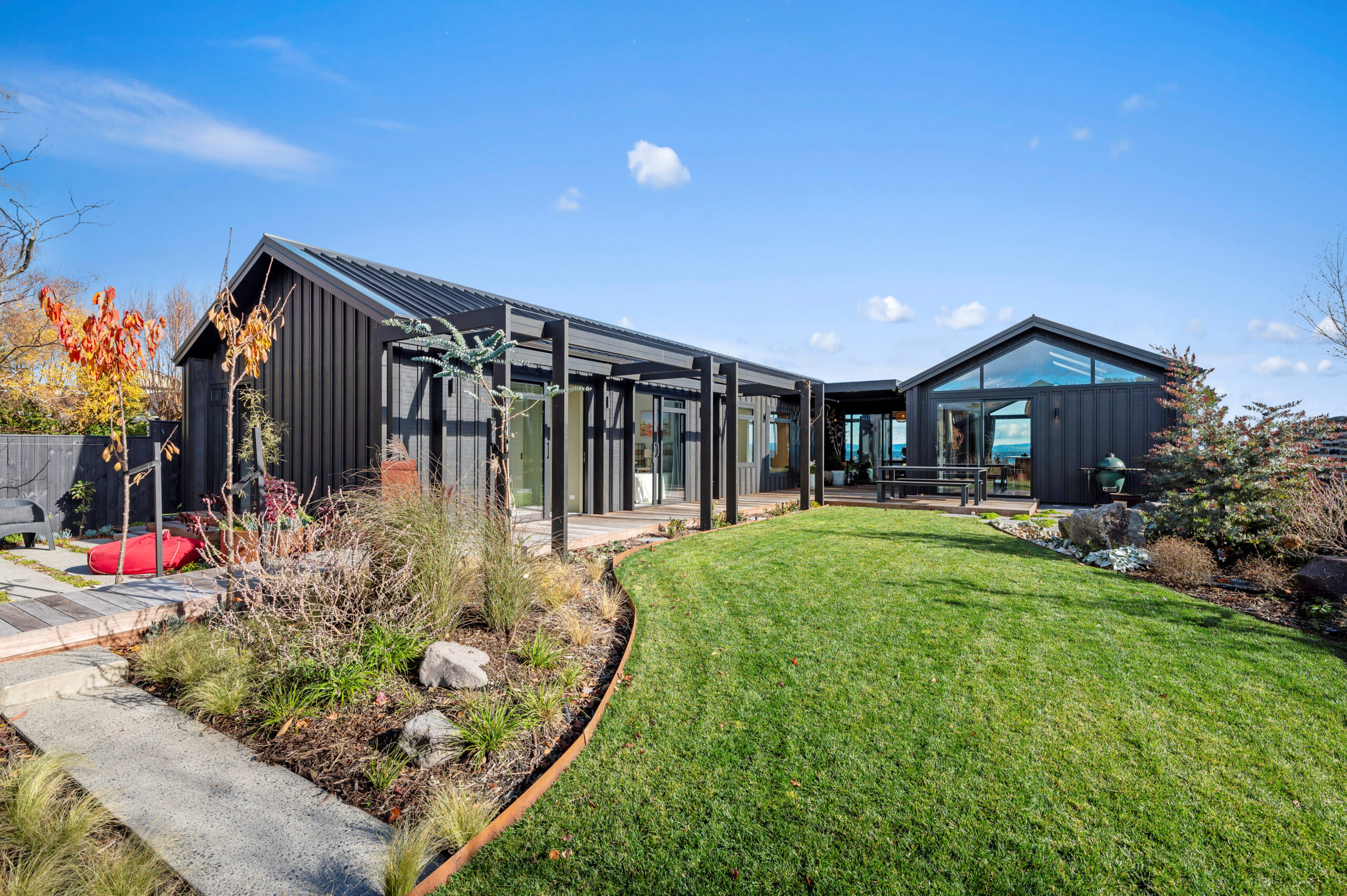 The landscape design creates an inviting backyard and compliments this new house and land.